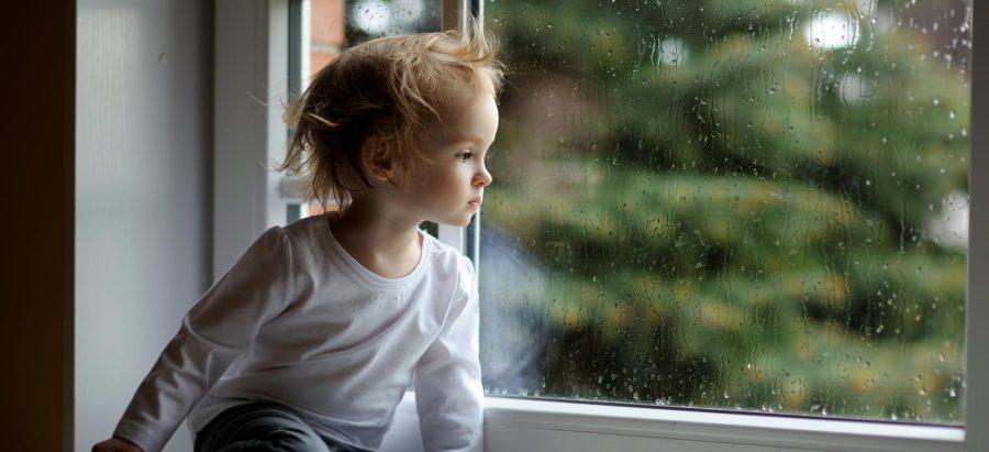 enfant qui regarde par la fenêtre